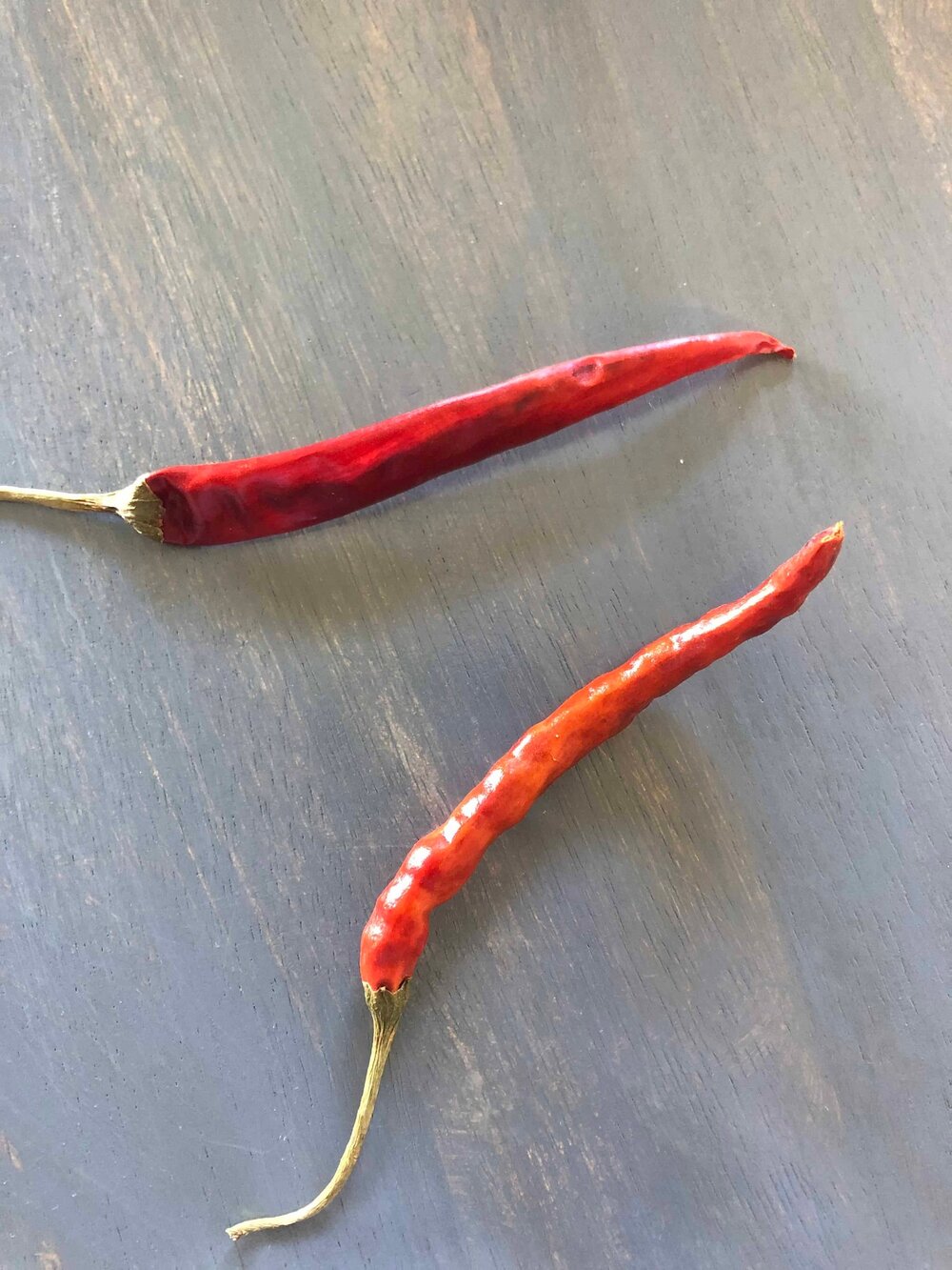 picture of beautiful dried red chili peppers on a farmhouse table top