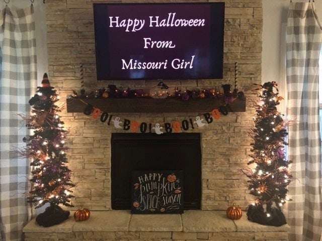 Fireplace decorated with Halloween tree and Halloween decor