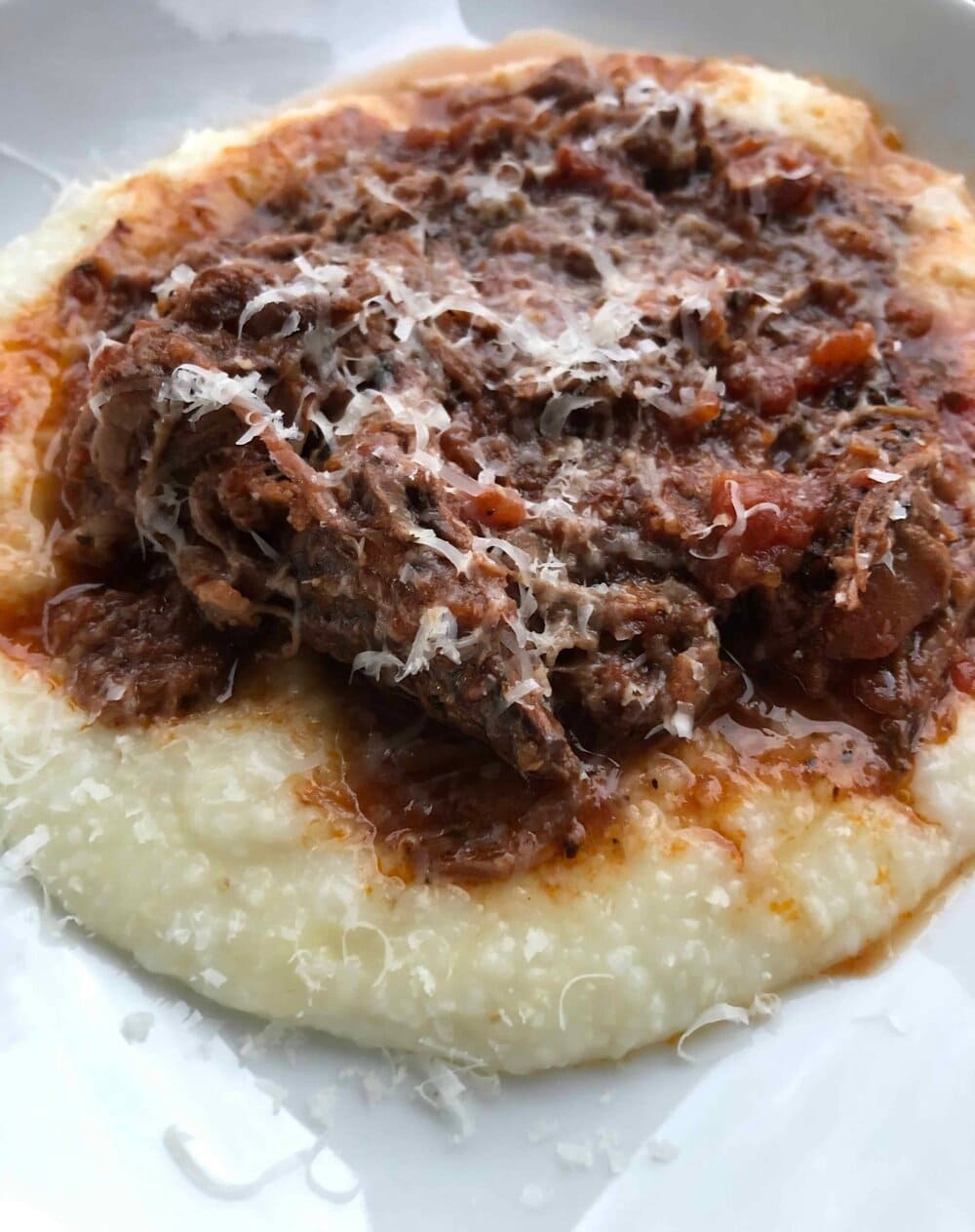 red wine braised beef with grits, sprinkled with Parmesan Cheese