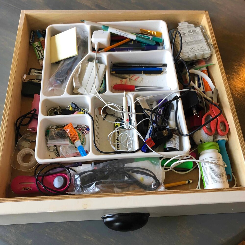 a picture of a very unorganized junk drawer