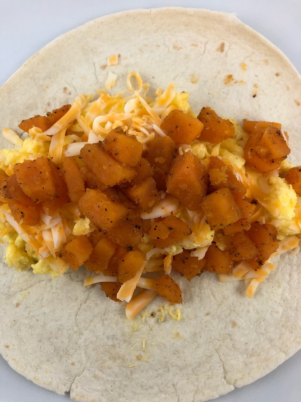 A Southwest breakfast burrito with scrambled eggs, cheese, sweet potatoes, spices, and salsa. Missouri girl.A Southwest breakfast burrito with scrambled eggs, cheese, sweet potatoes, spices, and salsa. Missouri girl. Missouri Girl Blog. #breakfast #brunch #breakfastburritos #eggs #sweetpotato #Missourigirl #Missourigirlblog
