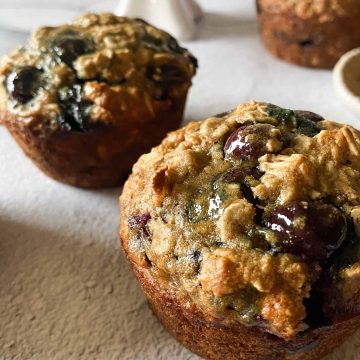 several blueberry and banana baked oatmeal cups with loads of blueberries