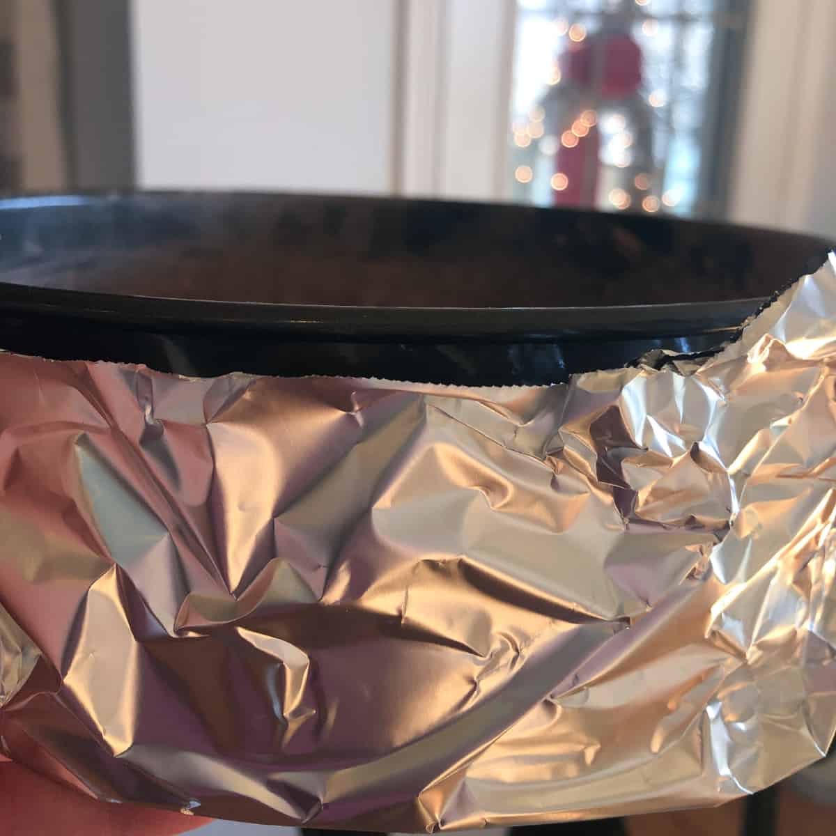 spring form pan surrounded with aluminum foil to prevent leaking