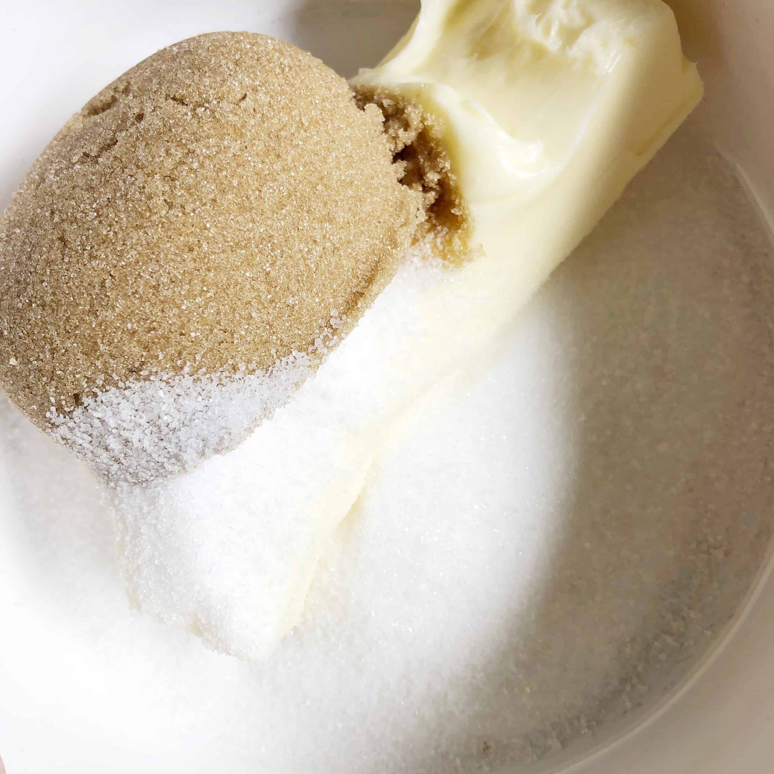 Hiland butter, brown sugar, and sugar in a bowl getting ready to be creamed together for chocolate chip cookies