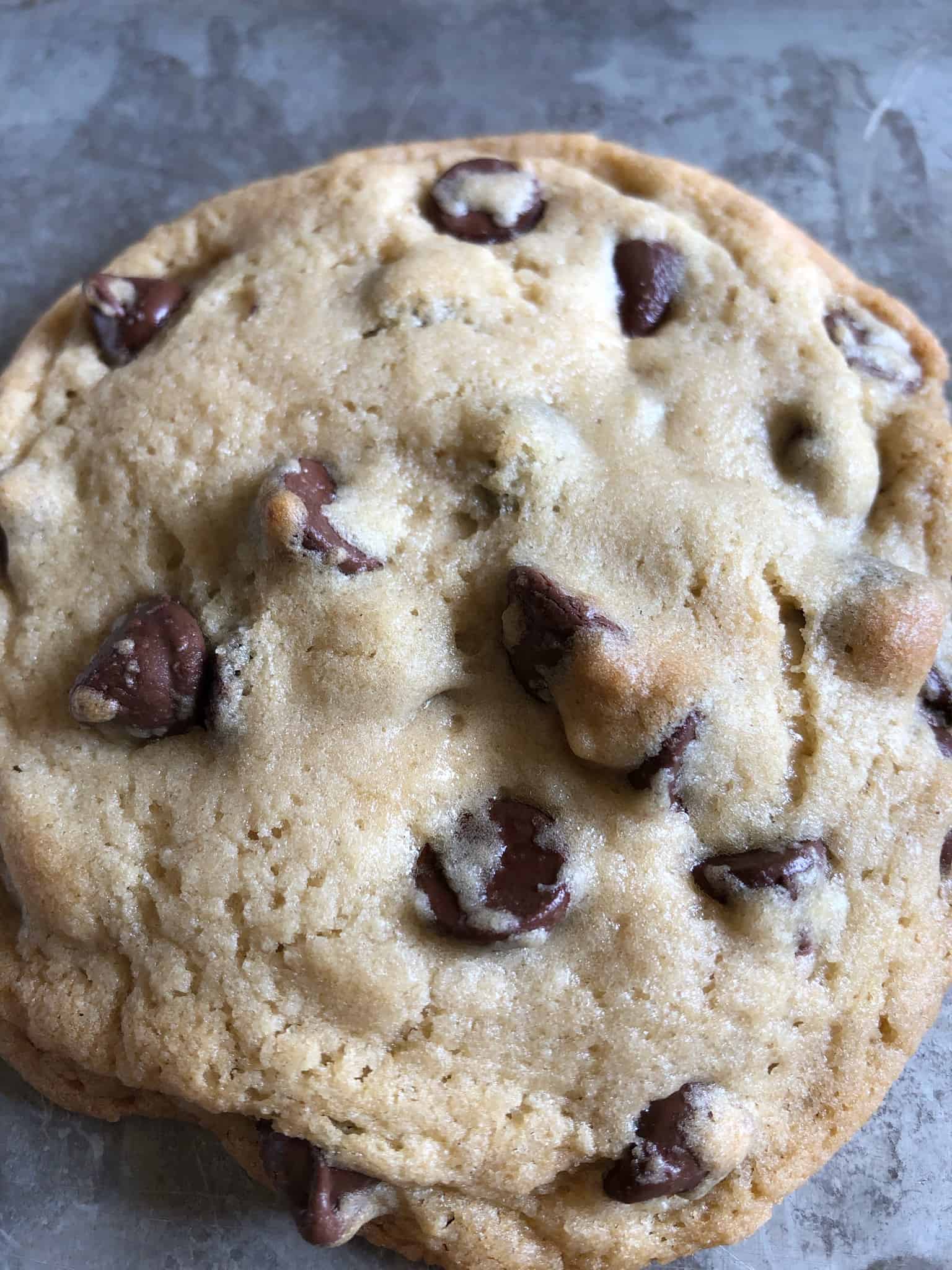 an under baked gooey chocolate chip cookie, straight from the oven