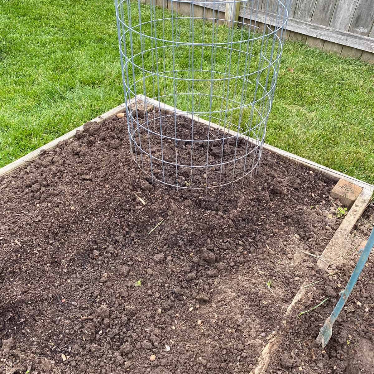 a pumpkin tower in a raised garden bed