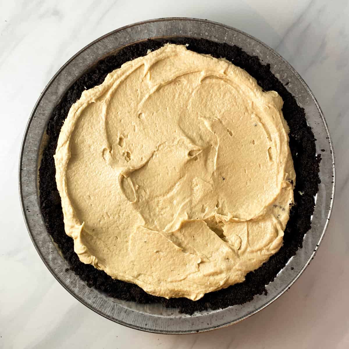 an oreo crust filled with a peanut butter cheesecake filling