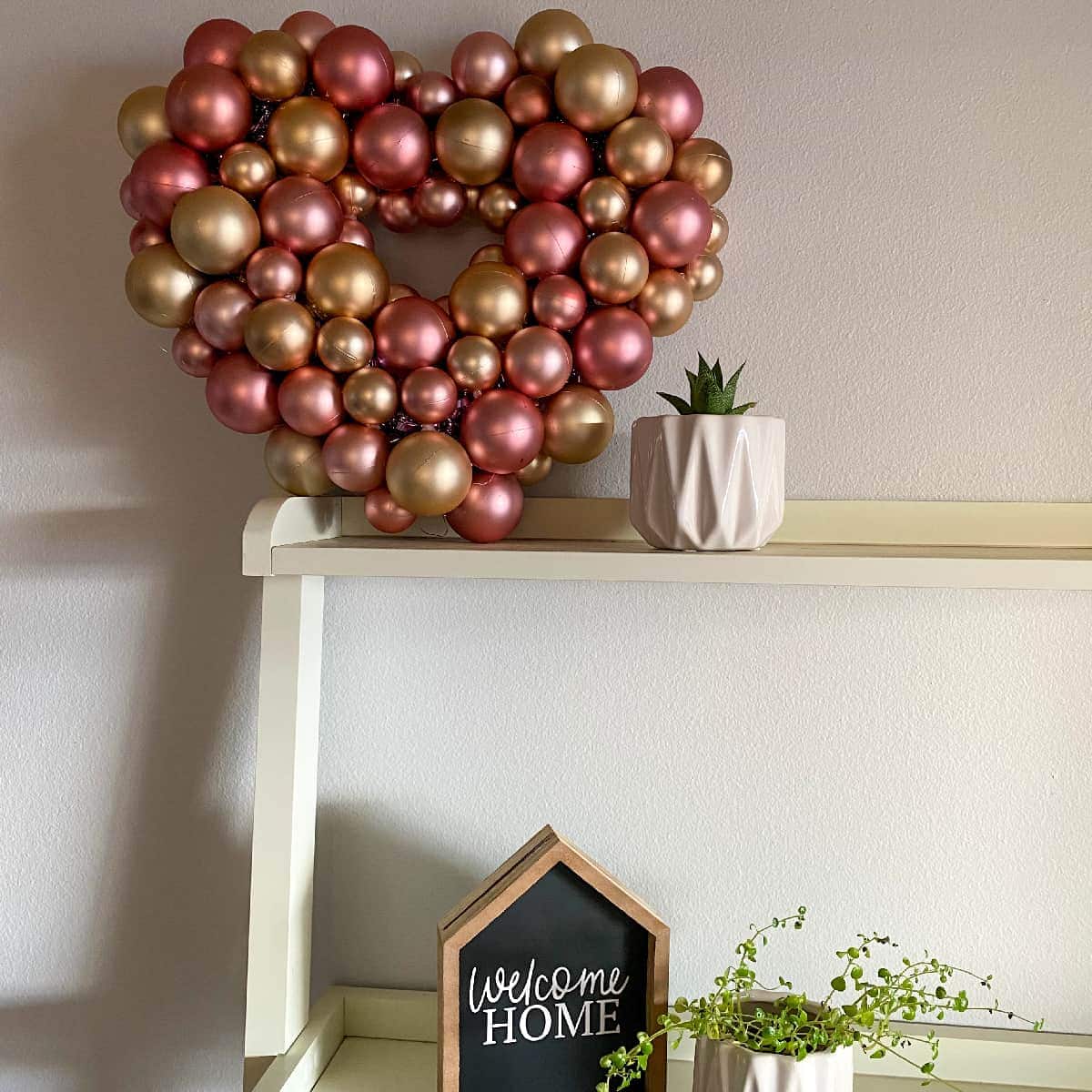 DIY Dollar Tree heart Valentine wreath sitting decoratively on a shelf. 