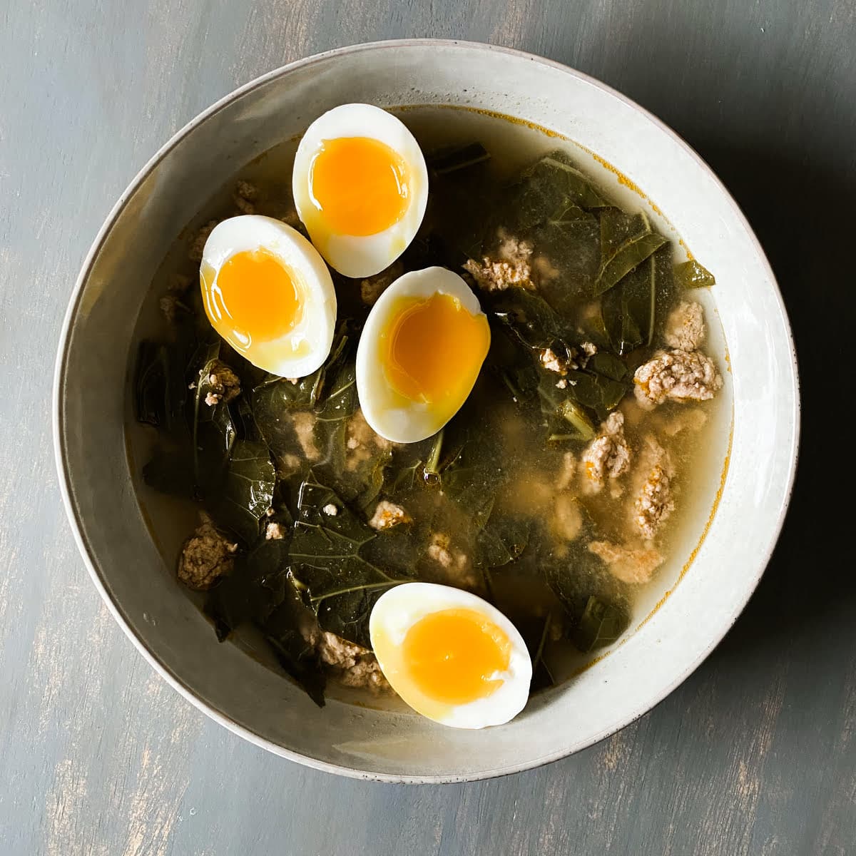 green detox collard green soup with 7 minute jammy eggs in a bowl
